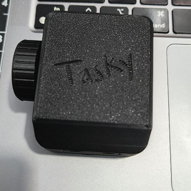 Top of Tasky's case, with the engraved logo